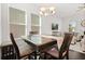 Well-lit dining area features a dark wood table with seating for six, with natural light and an open layout at 2405 Standing Rock Cir, Oakland, FL 34787