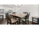 Formal dining room boasts a dark wood table with seating for six, with an open layout to the kitchen at 2405 Standing Rock Cir, Oakland, FL 34787