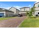 This home has a large paver driveway and a two-car garage at 2405 Standing Rock Cir, Oakland, FL 34787