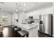 Modern eat-in kitchen with an island featuring granite countertops, stainless steel appliances, and plenty of counter space at 2405 Standing Rock Cir, Oakland, FL 34787