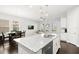 Bright open kitchen features a granite island, stainless steel appliances, and opens to living and dining areas at 2405 Standing Rock Cir, Oakland, FL 34787
