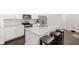 Modern kitchen island with granite countertops, stainless steel appliances, and bar stool seating at 2405 Standing Rock Cir, Oakland, FL 34787