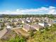Aerial view of the property showcasing its location in a neighborhood with lush greenery and a body of water nearby at 2636 Grand Central Ave, Tavares, FL 32778