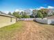 Fenced backyard with large grassy area providing space for outdoor activities and privacy at 2636 Grand Central Ave, Tavares, FL 32778