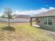 View of the backyard with a grassy lawn, fence, and covered patio at 2636 Grand Central Ave, Tavares, FL 32778