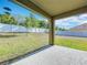 Spacious backyard featuring a well-maintained lawn, privacy fence, and a covered patio at 2636 Grand Central Ave, Tavares, FL 32778
