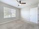 A bright bedroom with a ceiling fan and natural light from a large window at 2636 Grand Central Ave, Tavares, FL 32778