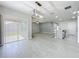 Open concept dining room with sliding glass door access to back yard, pendant lighting, and gray wood-look tile floors at 2636 Grand Central Ave, Tavares, FL 32778