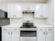 A well-appointed kitchen showcasing white cabinets, stainless steel appliances, and durable countertops at 2636 Grand Central Ave, Tavares, FL 32778