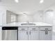 Stainless steel sink and dishwasher in kitchen island with pendant lighting and gray wood-look tile floors at 2636 Grand Central Ave, Tavares, FL 32778