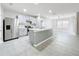 A spacious kitchen with stainless steel appliances, center island, and neutral color palette at 2636 Grand Central Ave, Tavares, FL 32778