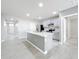 Bright, airy kitchen featuring a center island, stainless steel appliances, and open layout to living areas at 2636 Grand Central Ave, Tavares, FL 32778
