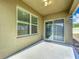 Covered patio with a large window and sliding glass door for indoor-outdoor living at 2636 Grand Central Ave, Tavares, FL 32778