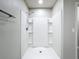An updated shower featuring an adjustable shower head and built-in shelving at 2636 Grand Central Ave, Tavares, FL 32778