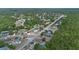 An aerial view of a neighborhood bordering a lush green forest preserve and a small lake at 2763 E Waco Dr, Deltona, FL 32738