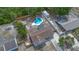 This aerial shot highlights the property, featuring a pool, patio, and fenced-in backyard at 2763 E Waco Dr, Deltona, FL 32738
