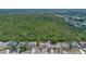 An aerial view of neighborhood homes, showcasing its prime location next to a sprawling green forest preserve at 2763 E Waco Dr, Deltona, FL 32738
