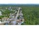 Aerial view features a home and neighborhood bordering a lush green forest preserve for added privacy at 2763 E Waco Dr, Deltona, FL 32738