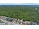 An aerial view showcasing a neighborhood's proximity to an expansive green forest preserve, offering privacy at 2763 E Waco Dr, Deltona, FL 32738