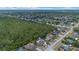 An aerial view showing the property with a pool nestled next to a lush green forest preserve at 2763 E Waco Dr, Deltona, FL 32738