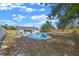 Aerial view of the backyard with a kidney-shaped pool, fenced perimeter, and attached screened patio at 2763 E Waco Dr, Deltona, FL 32738