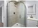 Bathroom with walk-in shower featuring marble tile and a modern sink at 2763 E Waco Dr, Deltona, FL 32738
