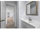 Hallway view of a bathroom vanity and mirror, showcasing modern fixtures and clean lines with a bright aesthetic at 2763 E Waco Dr, Deltona, FL 32738