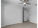 A bright bedroom features a ceiling fan, light blue walls, and a spacious closet, blending comfort with practical design at 2763 E Waco Dr, Deltona, FL 32738