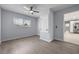 Bedroom with wood-look flooring, a ceiling fan, and a closet door at 2763 E Waco Dr, Deltona, FL 32738