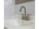 Close-up of a modern brushed nickel faucet and white countertop, highlighting the bathroom's clean design and updated fixtures at 2763 E Waco Dr, Deltona, FL 32738