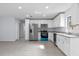 Spacious kitchen with stainless steel appliances, granite countertops, and white cabinetry at 2763 E Waco Dr, Deltona, FL 32738