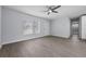 Spacious living room features wood-look floors, a ceiling fan, and natural light at 2763 E Waco Dr, Deltona, FL 32738