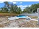 Backyard featuring kidney-shaped pool with blue tile, concrete patio, wood and vinyl fences at 2763 E Waco Dr, Deltona, FL 32738