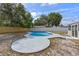 Backyard showcasing a kidney-shaped pool with stone patio and wooden fence at 2763 E Waco Dr, Deltona, FL 32738