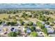 Aerial view of a neighborhood highlighting single-Gathering homes, mature trees, and convenient street access at 2995 White Magnolia Loop, Clermont, FL 34711