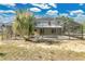 Backyard view of the screen-enclosed pool, spa, and home exterior on a sunny day at 2995 White Magnolia Loop, Clermont, FL 34711