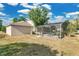 Backyard with screened in pool, and partial view of the back of the house, and an air conditioning unit at 2995 White Magnolia Loop, Clermont, FL 34711