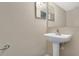 Bathroom featuring a pedestal sink and mirror, with clean white fixtures and neutral wall color at 2995 White Magnolia Loop, Clermont, FL 34711