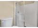 A clean, bright bathroom featuring a shower with glass doors, and a standard toilet at 2995 White Magnolia Loop, Clermont, FL 34711