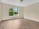 Bright and spacious bedroom with wood floors and a large window with natural light at 2995 White Magnolia Loop, Clermont, FL 34711