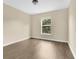 Inviting bedroom with wood floors and a bright window offering natural light and street views at 2995 White Magnolia Loop, Clermont, FL 34711