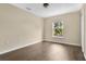 This is a neutral-toned bedroom with a window, light hardwood floors, and a ceiling fan at 2995 White Magnolia Loop, Clermont, FL 34711