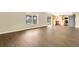Bright living room with hardwood floors, large window, and open layout, with easy access to the kitchen at 2995 White Magnolia Loop, Clermont, FL 34711