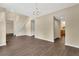 Open-concept living area with staircase, hardwood floors, and natural light, offering ample space for relaxation and entertainment at 2995 White Magnolia Loop, Clermont, FL 34711