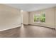 Bright living room with hardwood floors, large window, and neutral paint, offering a welcoming space at 2995 White Magnolia Loop, Clermont, FL 34711