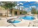 Screened-in pool area with a in-ground pool and spa, a large concrete patio, and home exterior at 2995 White Magnolia Loop, Clermont, FL 34711