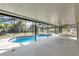 A screened pool area featuring a pool with a blue tile trim, and an extra large concrete patio area at 2995 White Magnolia Loop, Clermont, FL 34711
