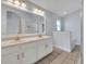 Bathroom featuring a double vanity sink, large mirror, tile flooring, and a shower at 314 Lady Diana Dr, Davenport, FL 33837