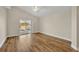 Bright main bedroom with wood floors, ceiling fan, and sliding door access to screened patio at 314 Lady Diana Dr, Davenport, FL 33837