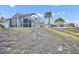 Back exterior of the home showing the screened in pool, view of neighborhood, and back yard at 314 Lady Diana Dr, Davenport, FL 33837